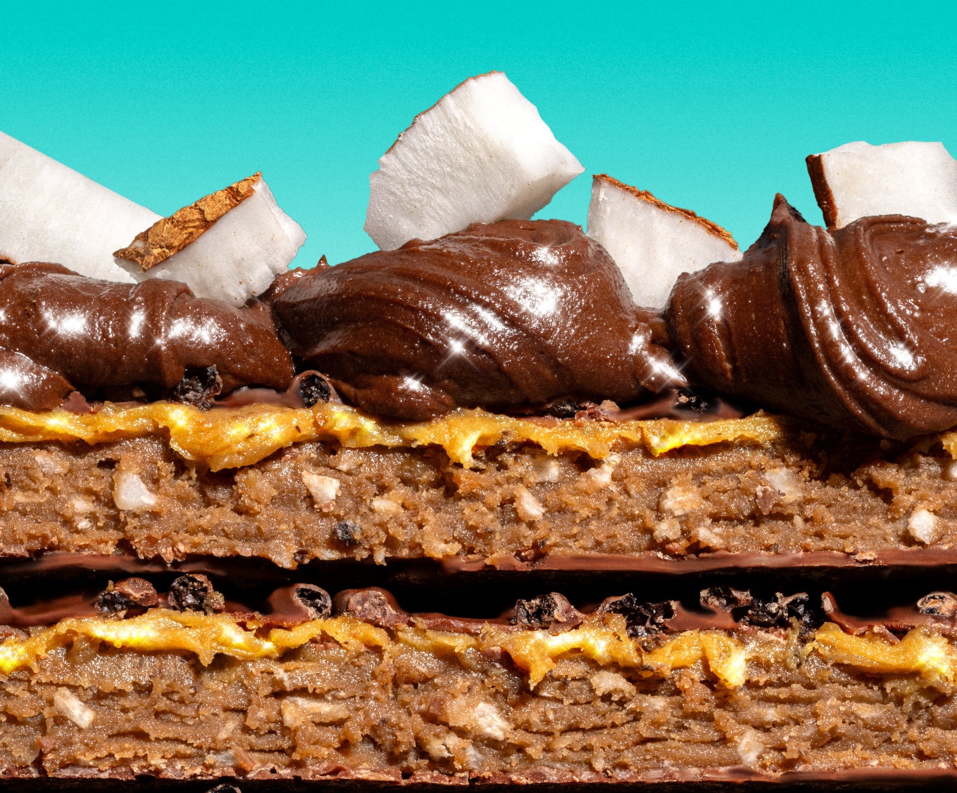 Close-up of layered dessert with chocolate, coconut, and caramel